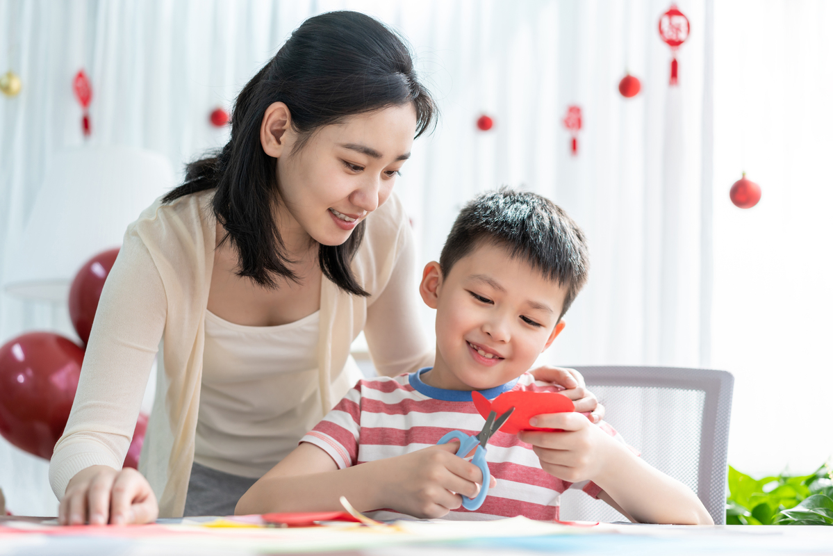 mum and son cutting paper