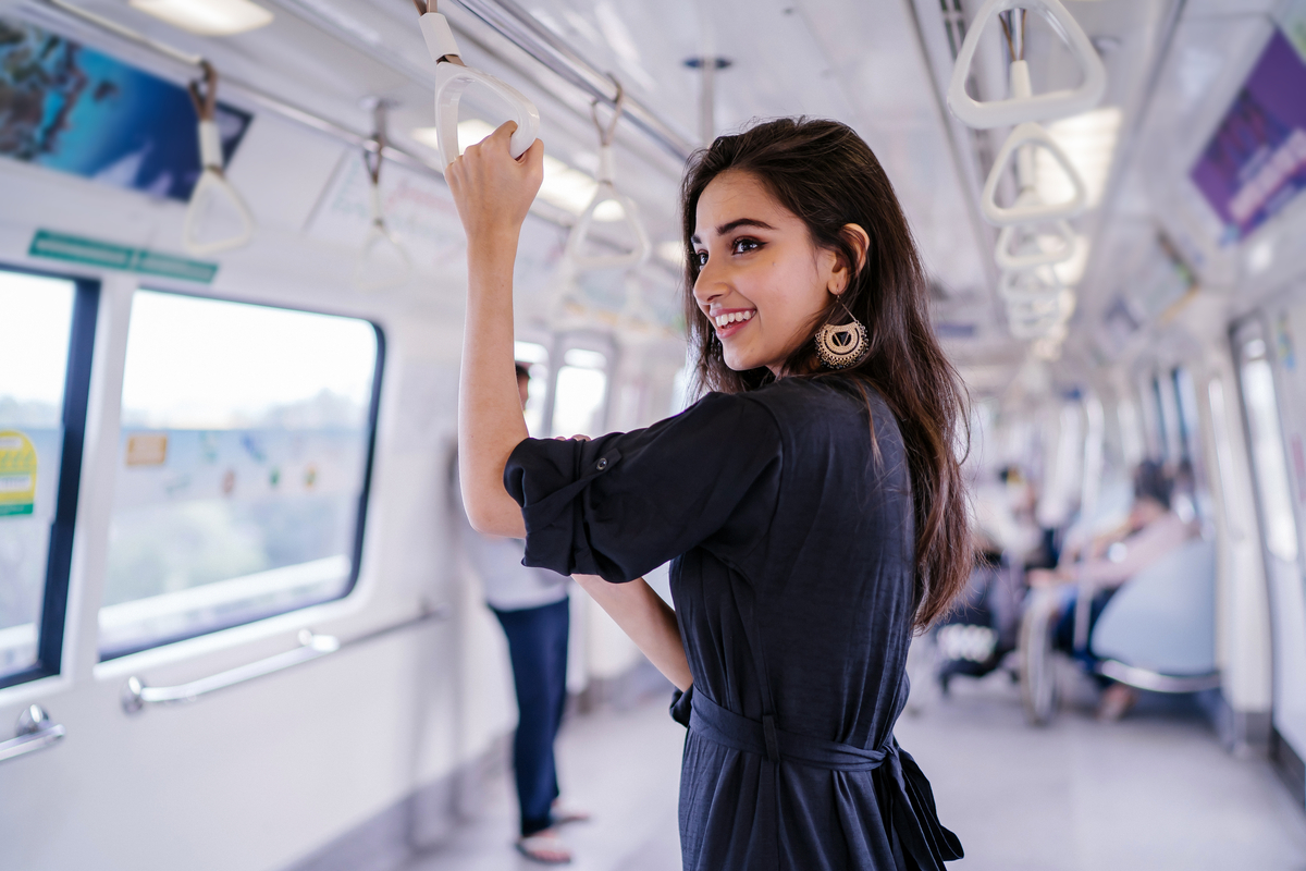 Lady holding handle bar in MRT