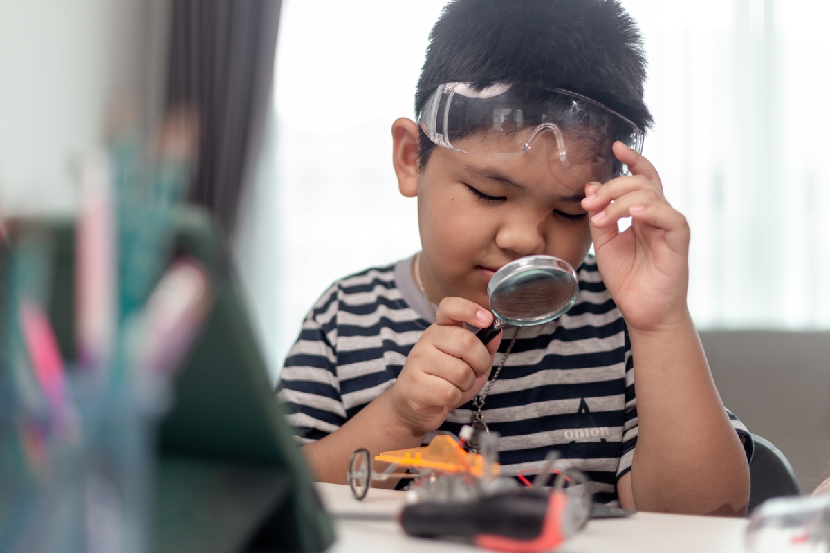 Boy using magnifying glass