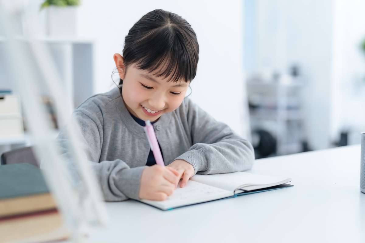 Girl writing on book, studying to avoid math errors or common math mistakes