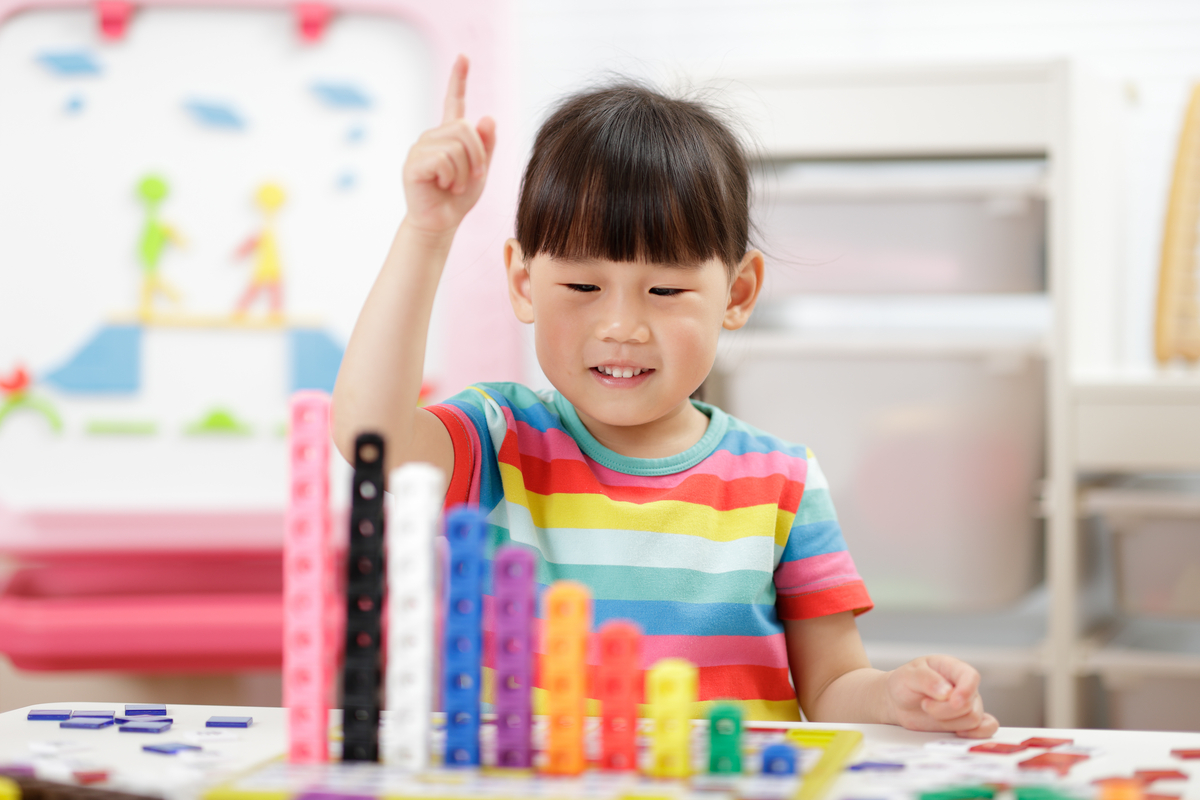 Young preschooler counting figures