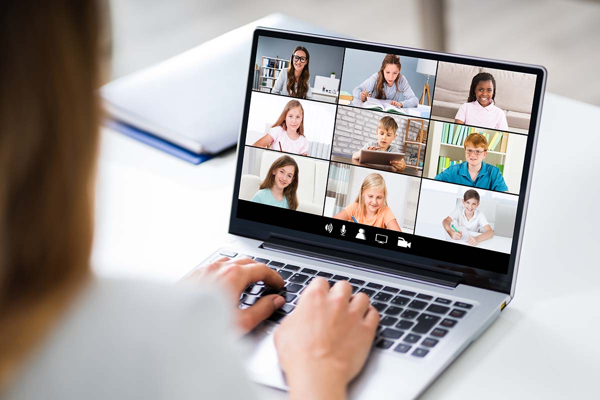 Online Teachers laptop screen filled with students remote learning