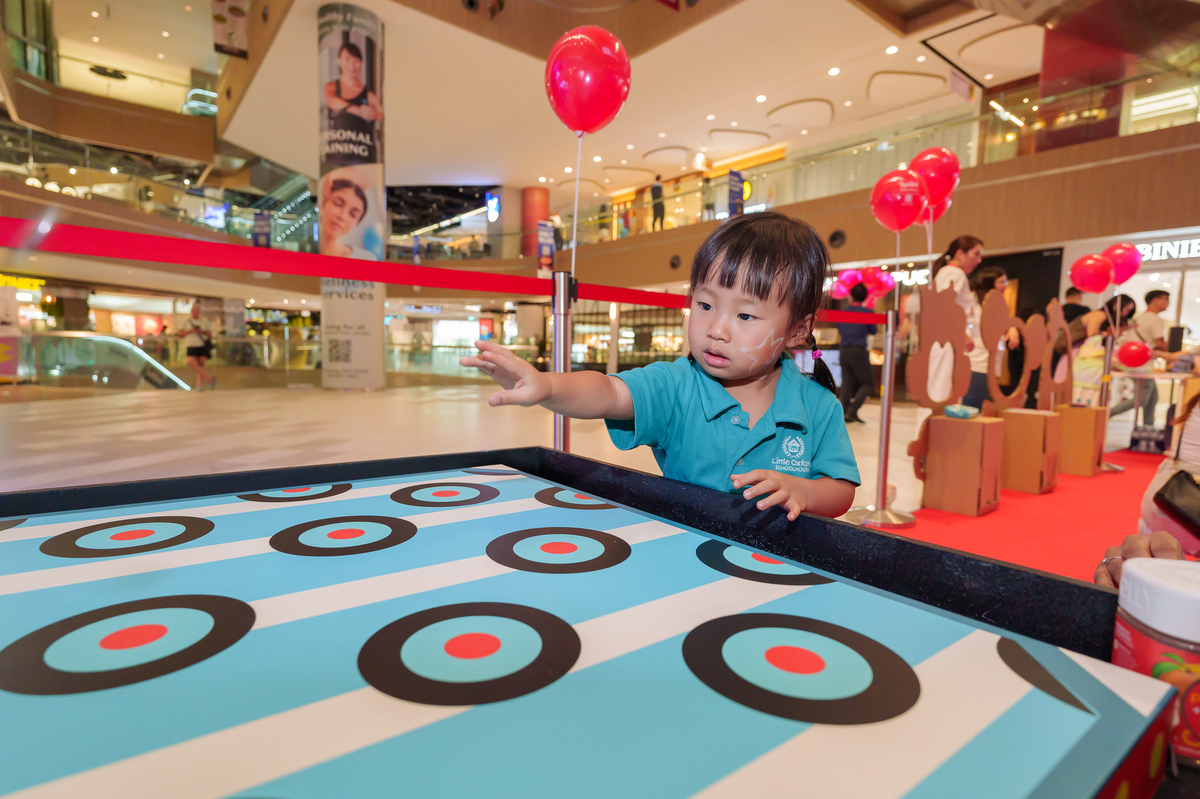 Children's Day Celebration child playing coin toss game