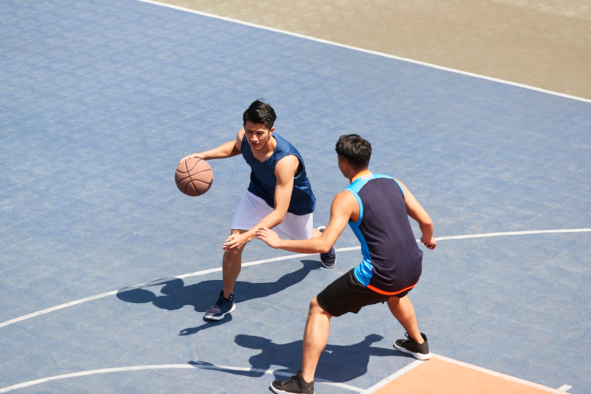 Fun Basketball Math Facts for Kids two men playing basketball in basketball court