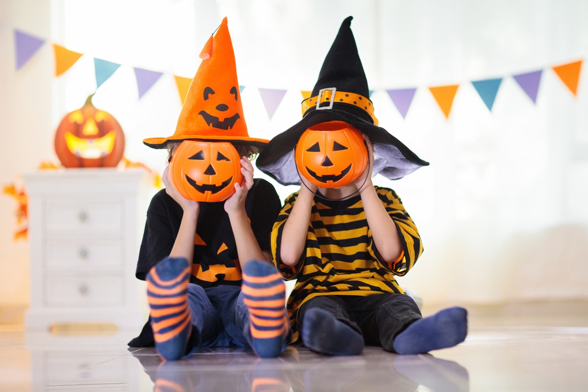 Free Primary 1 Math Worksheets for Halloween two children dressed up and holding pumpkins
