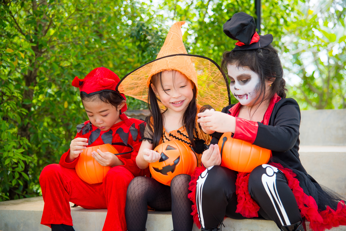 Free Primary 3 Math Worksheets for Halloween children holding pumpkin baskets going trick or treating and dressed up