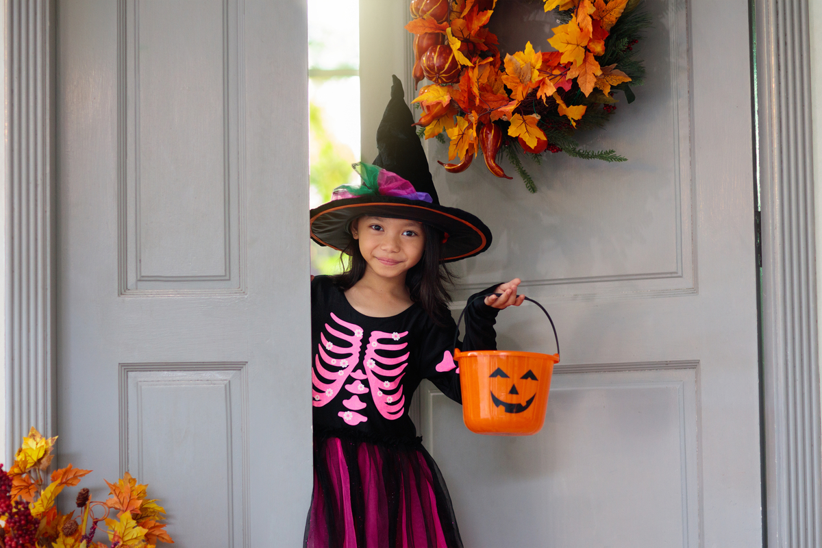 Free Primary 3 Math Worksheets for Halloween girl going trick or treating and dressed up as a witch