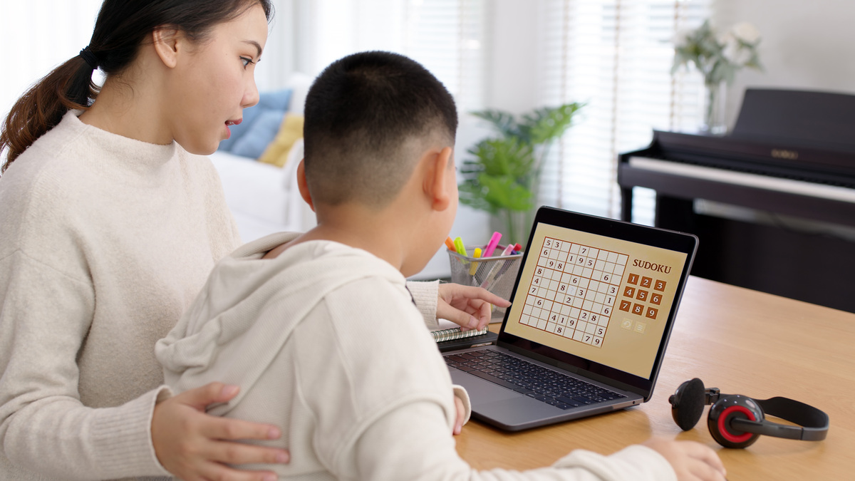 Free Sudoku Worksheets Spark Global Sudoku Challenge mother and child playing Sudoku game