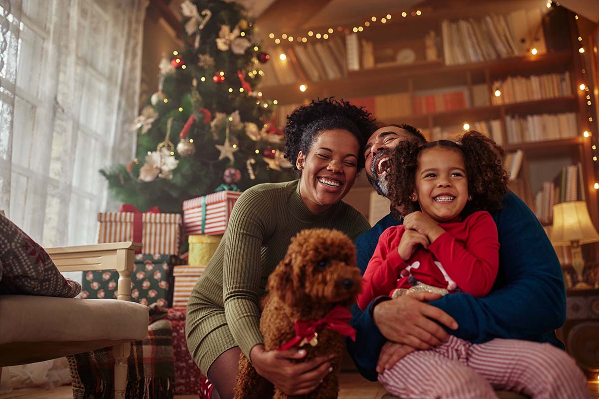 Family taking a photo Christmas morning. Spark's Educational Holiday Gift Guide!  Perfect Gifts for kids who love STEM! Educational Christmas Gift Guide