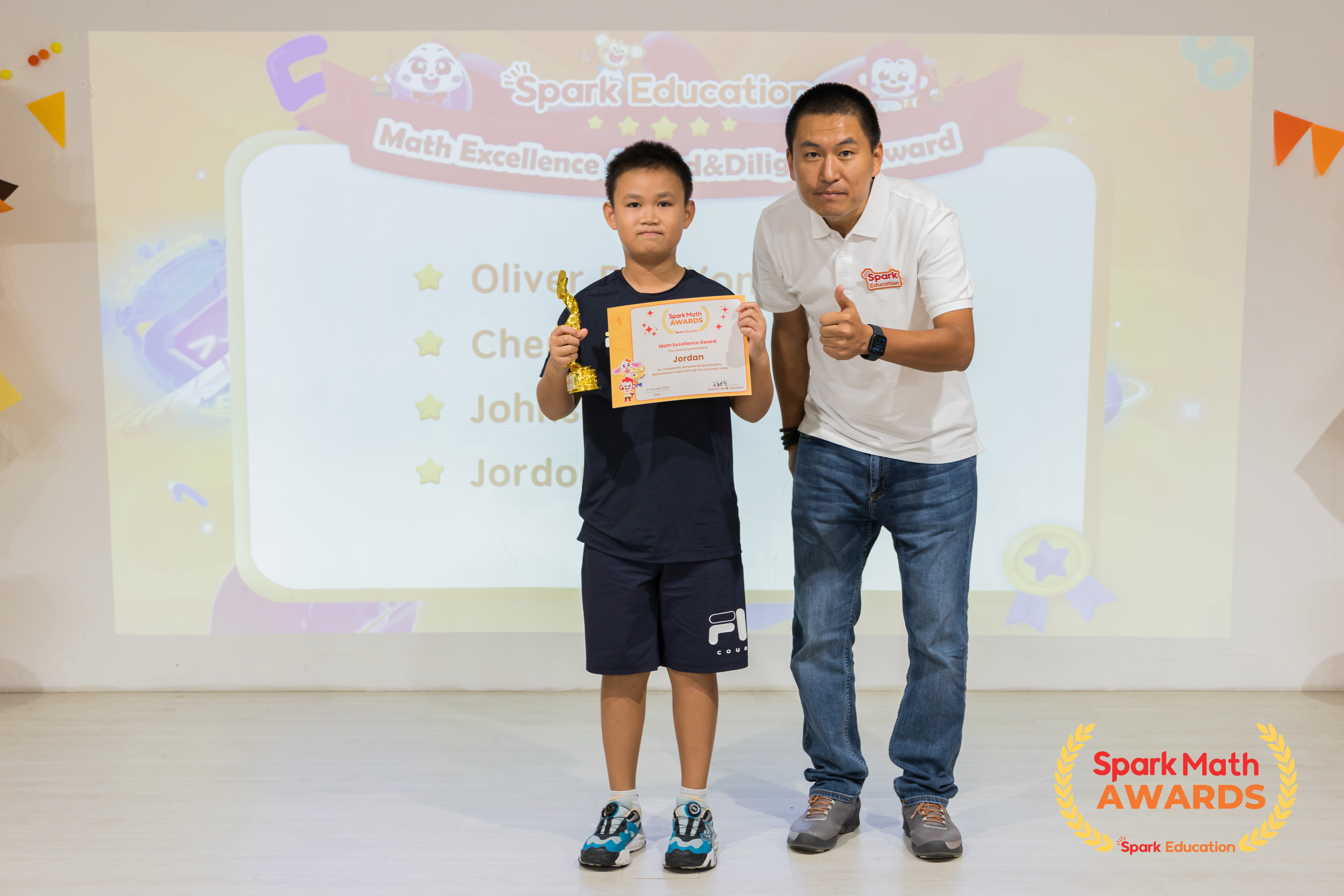 Mr. Owen Zhang, Manager of Spark Learning Centre at i12 Katong, presenting Math Excellence awards to Spark Math students with consistent top-notch performance.