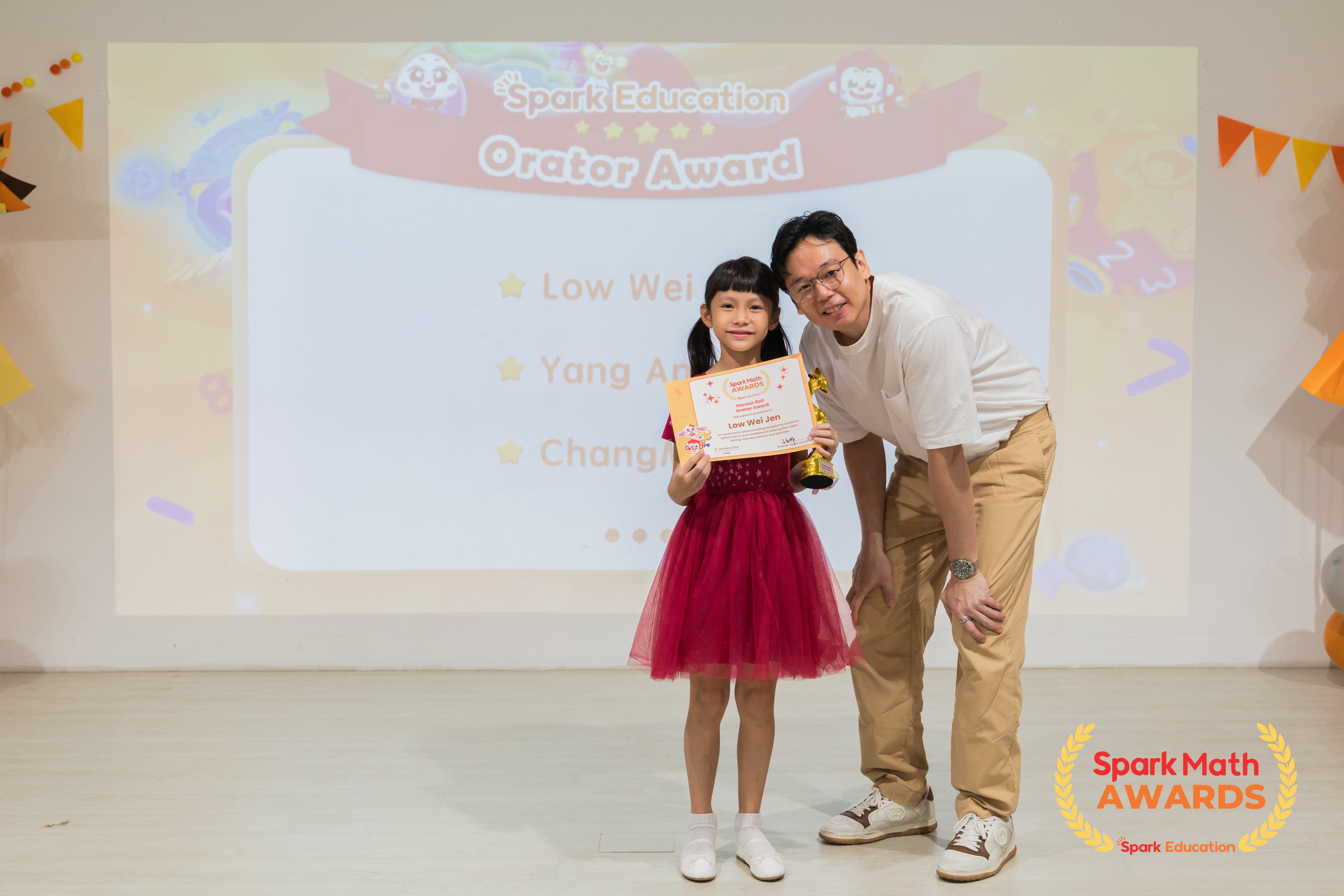 Teacher Roy, Upper Primary Curriculum Specialist, presenting Honour Roll and Orator awards to top performing Spark Math students who have shown confidence in sharing ideas in class discussions and Little Teacher Presentations.