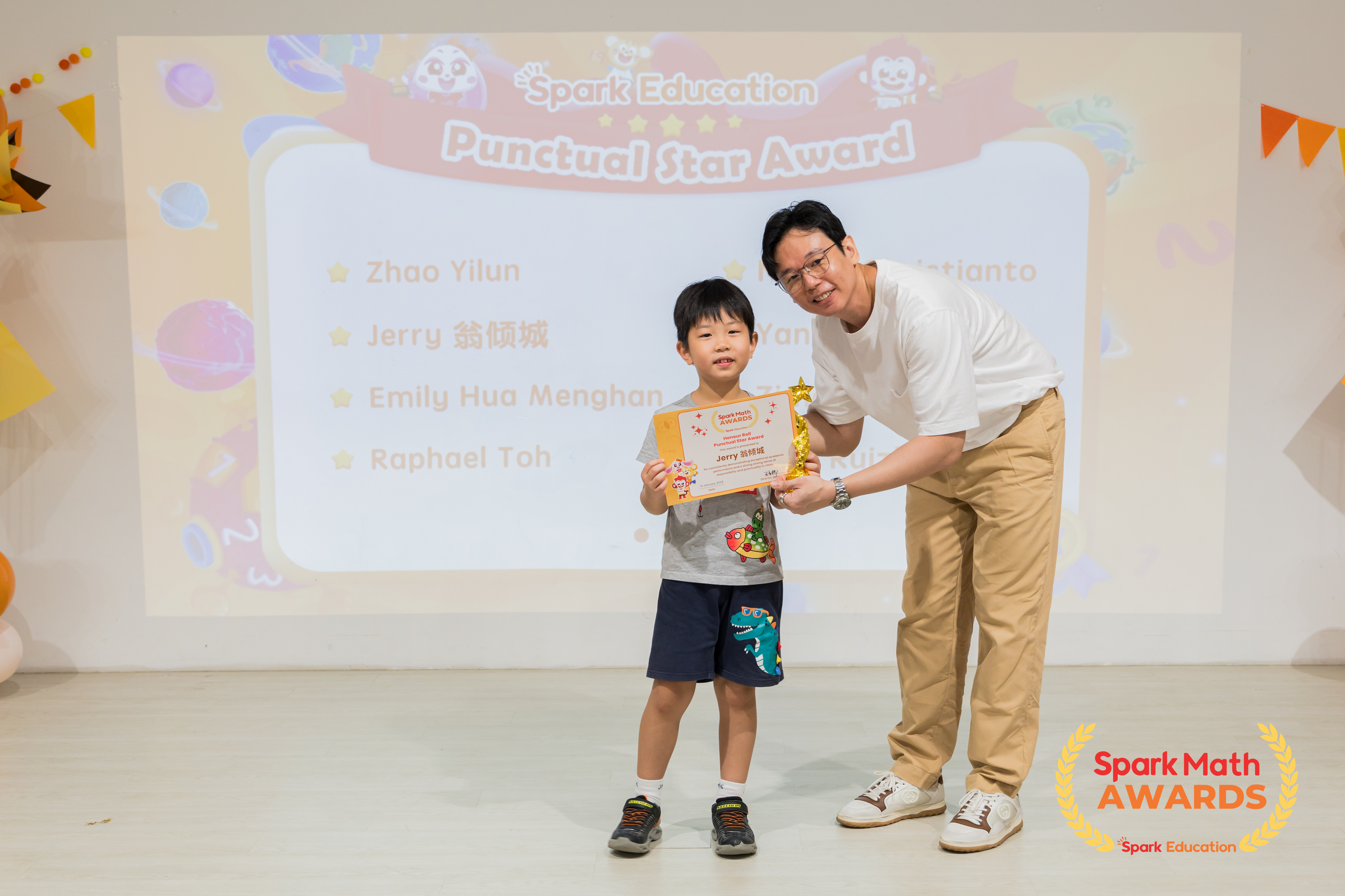 Teacher Roy, Upper Primary Curriculum Specialist, presenting the Honour Roll and Punctual Star awards to top performing Spark Math winners who have shown a great sense of responsibility and punctuality in all their learning activities.