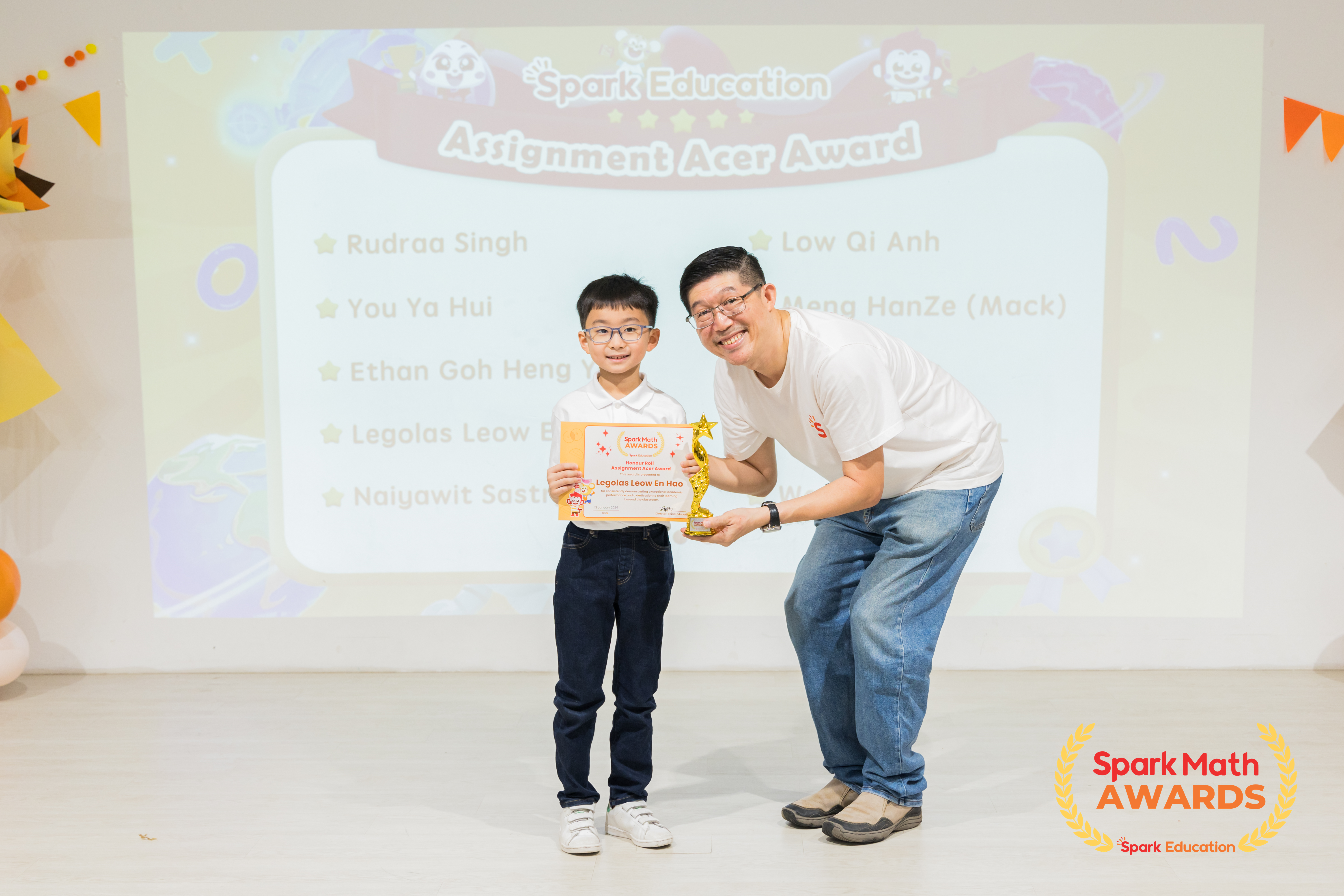 Teacher Winston, Upper Primary Curriculum Specialist, presenting the Honour Roll and Assignment Acer awards to top performing Spark Math winners who have shown dedication to learning beyond the classroom.