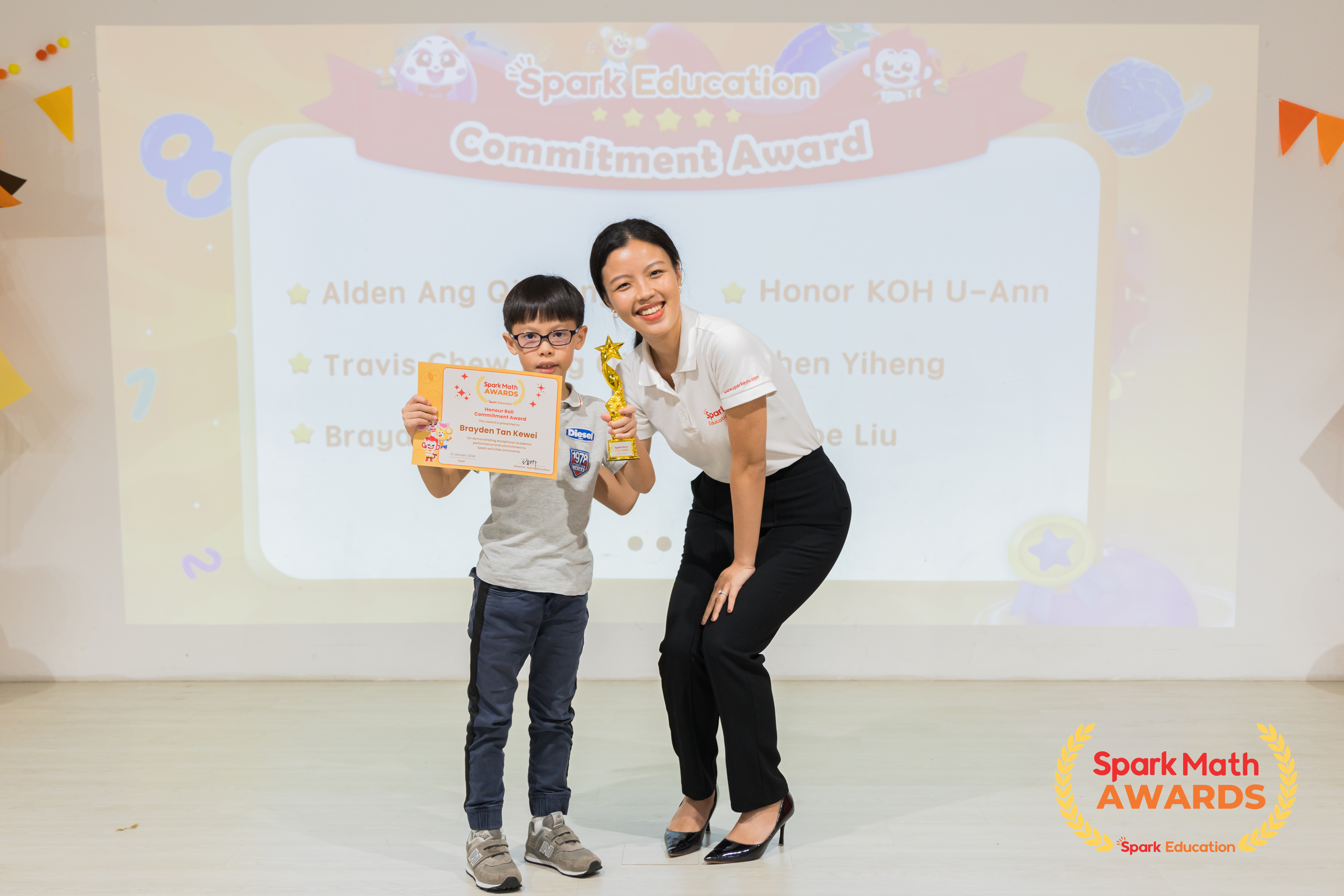 Teacher Zoe, Lower Primary Curriculum Specialist, presenting the Honour Roll and Commitment awards to Spark Math top performers who not only excel academically but also actively support in all Spark activities and events. 